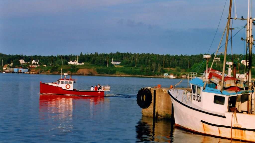 18 Hidden Gems in Canada Where You Can Escape the Modern World 10 Cape Breton Highlands Nova Scotia boat beach place