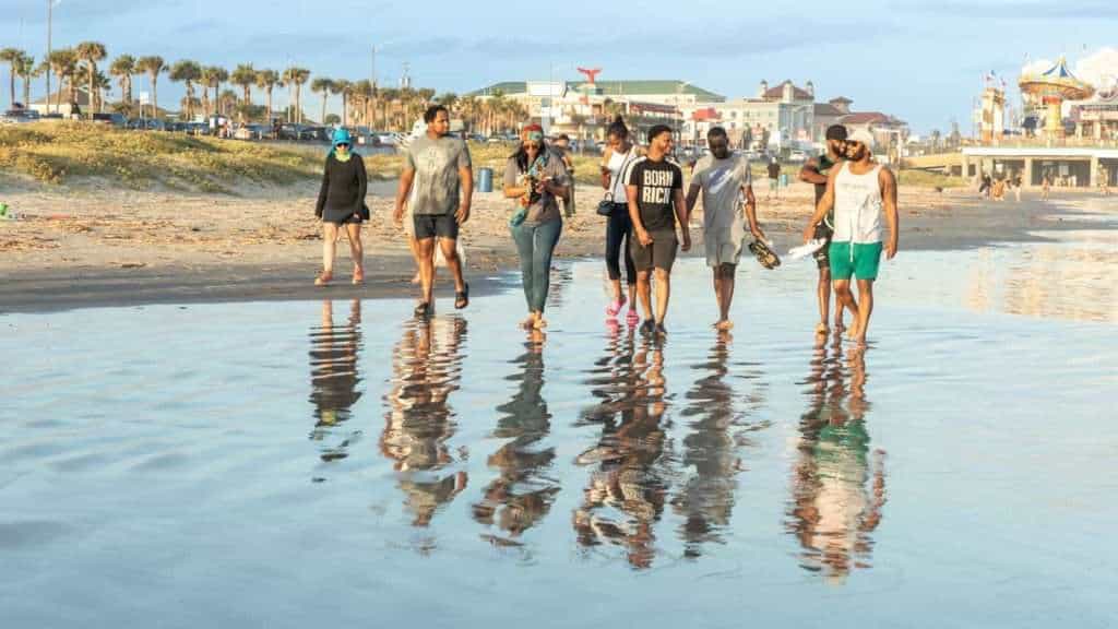 19 Best Group Travel Tours for Older Travelers 13 Galveston Island Texas people travel beach