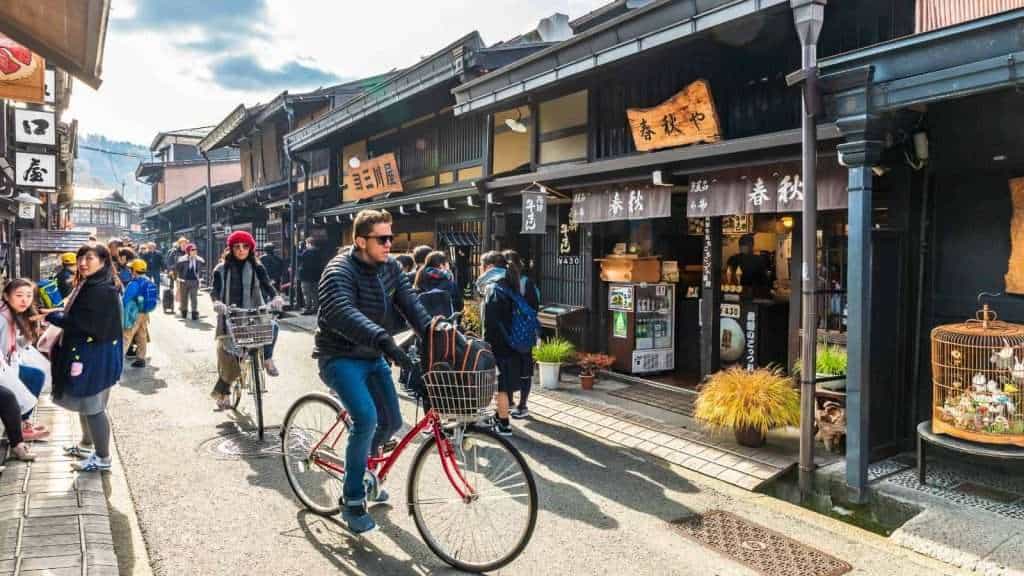 18 Gorgeous Mountain Villages That Feel Like a Hidden World 3 Takayama Japan people bike travel biking