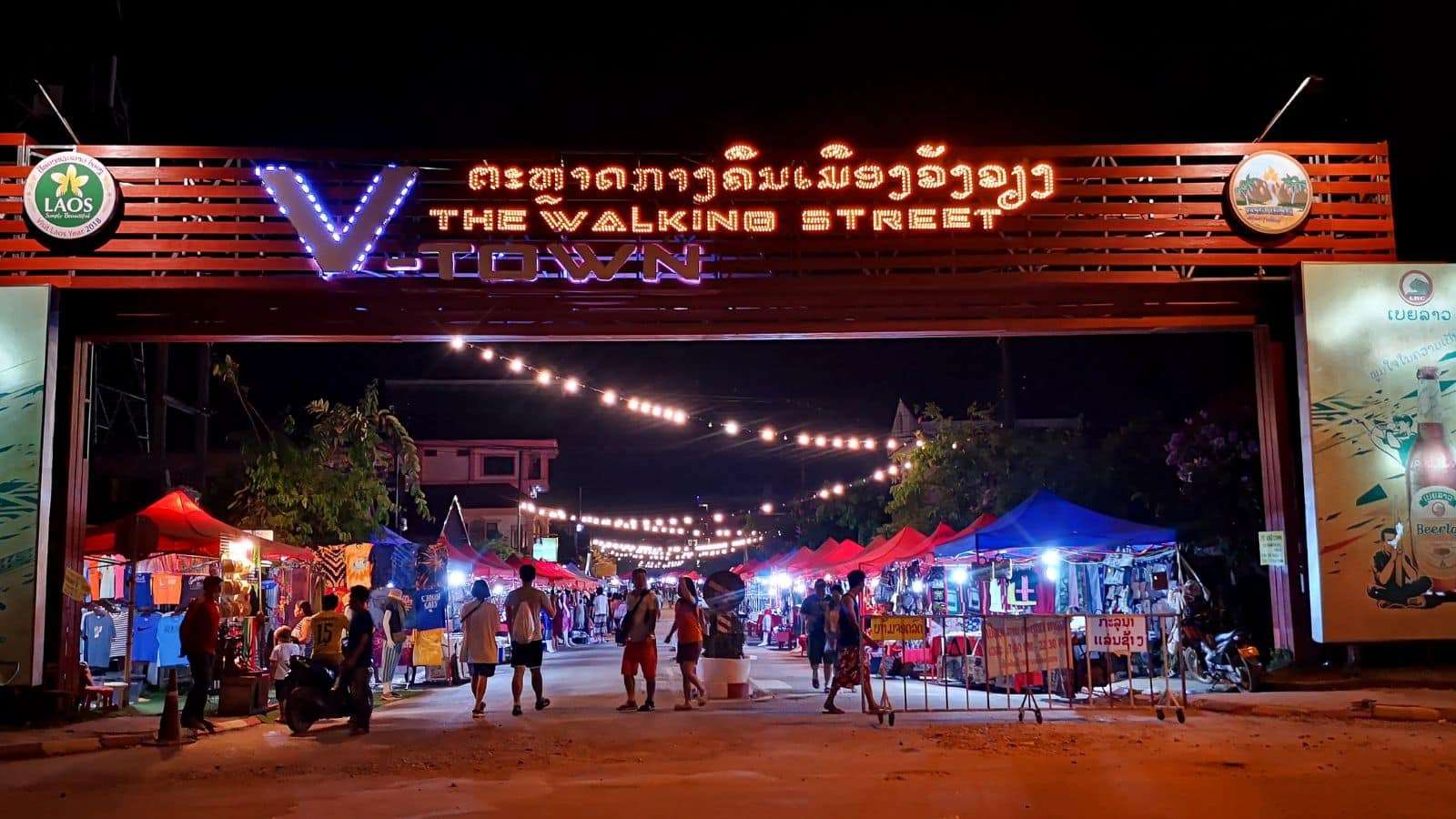 23 Places to Travel Without Going Broke 9 Vang Vieng Laos people walking