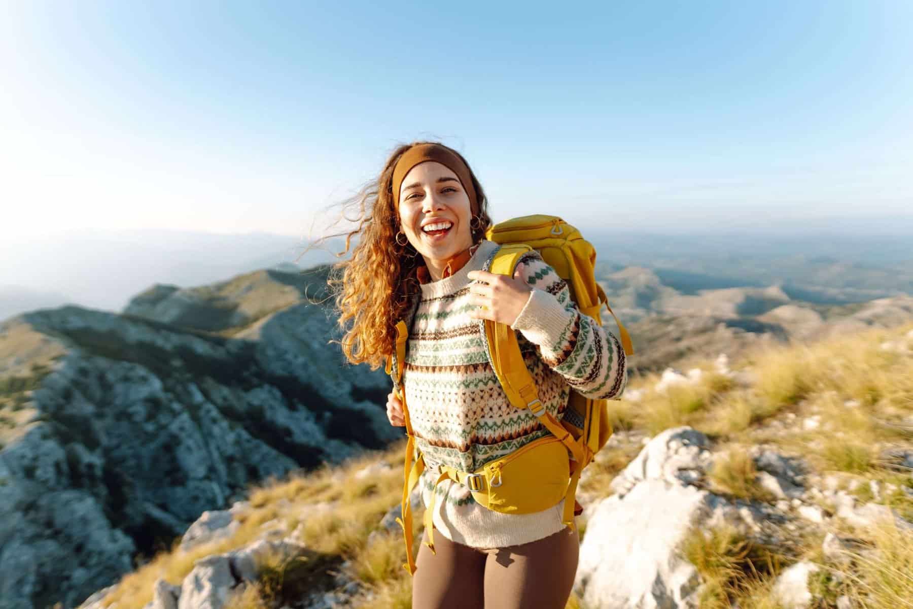 21 Affordable Vacations With Stunning Views 23 Traveler,Woman,Backpacker,On,Mountains,Cliff,Hiking,Enjoy,Landscape.,Hiking
