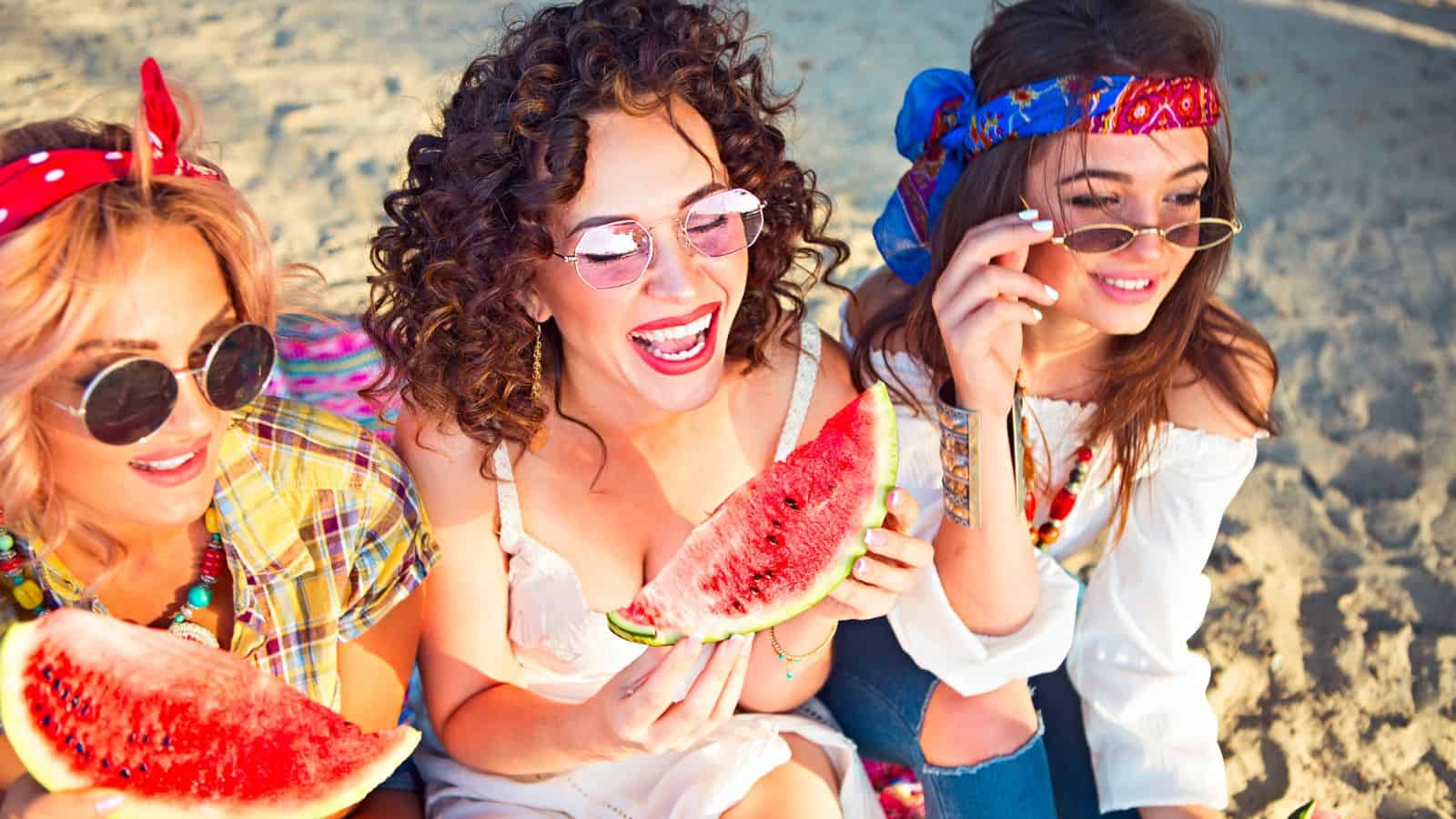 Celebrate Like a Local: 22 Small-Town Festivals With Big-Time Spirit and Hometown Flavor — You’ll Want to Make It an Annual Tradition 26 Women eating watermelons, festival - Depositphotos_237593070_L (1)