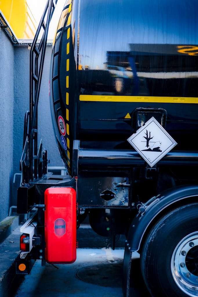 20 American Disaster Towns Forever Marked by One Terrifying Day 11 Detailed view of a hazardous material tank truck with warning sign, emphasizing safety.