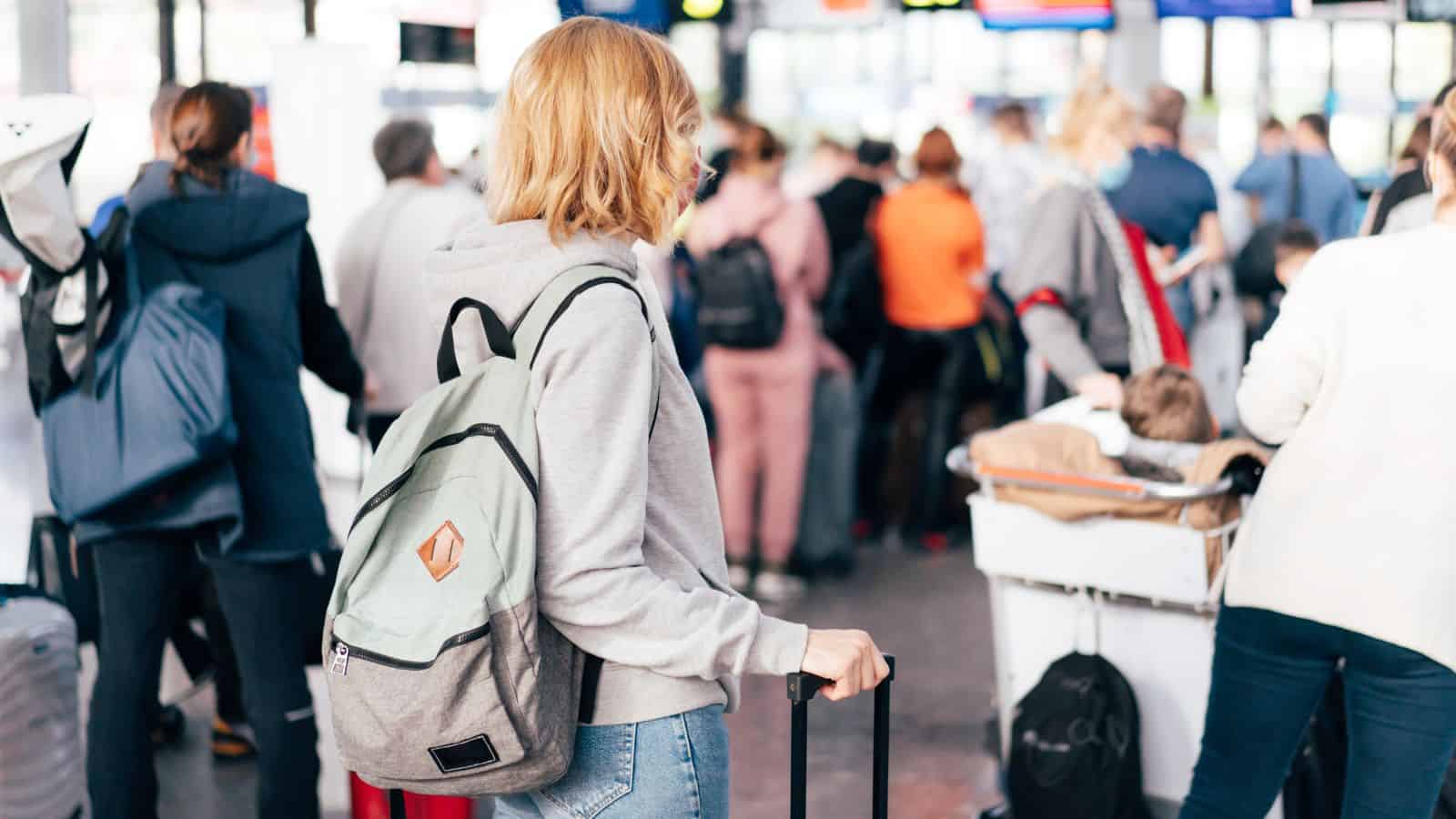 Long lines at airport security girl with backpack